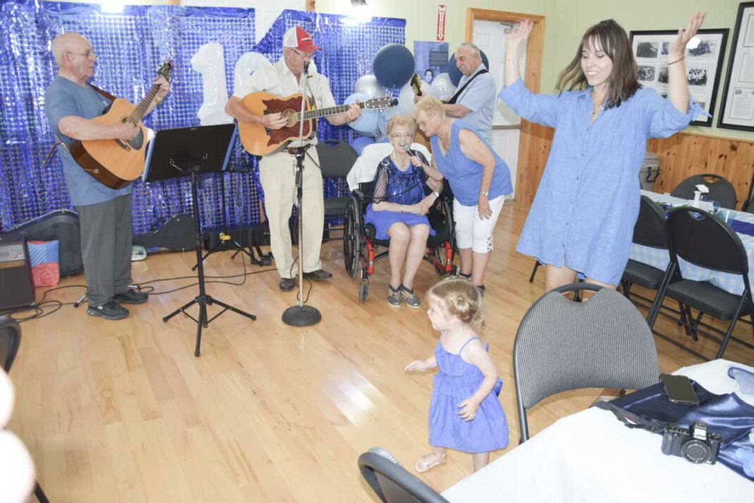 Still fiesty, 100-year-old Rose McIntosh takes a turn at the mic during her birthday celebrations.