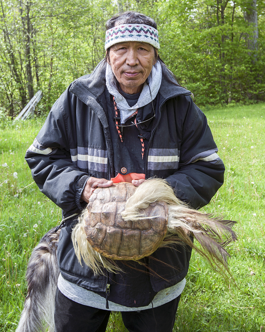 Leo Bebonung with a turtle hat used for ceremony. Mr. Bebonung lives off the grid in a log cabin on the outskirts of M’Chigeeng First Nation. 