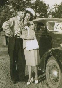 Bud McConnell and his bride Dorothy pose beside the Just Married sign.