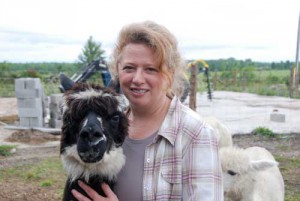 Heather Crowder and farm mascot Shadow, the cuddly alpaca.