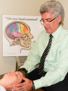 Dr. Dario Laurenti  demonstrates a cranial  adjustment.