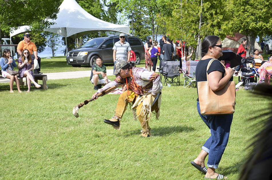 A traditional warrior dancer struts his stuff in the dance arena.