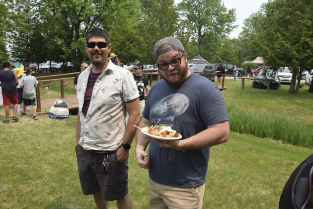 Jimmy Mayhew and Nathan Stephens enjoy some traditional powwow fare.