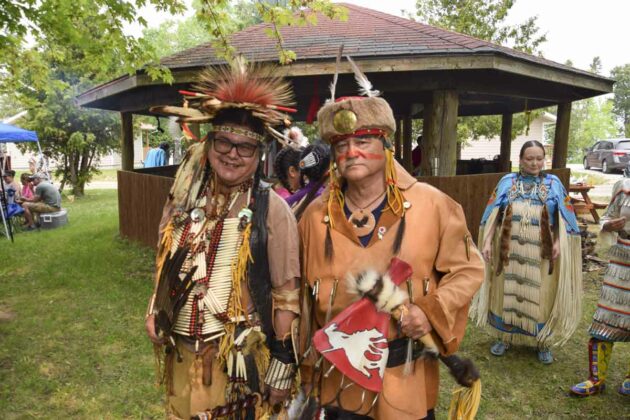 Powwow traditional mens dancers artist Melvin Madahbee and retired political operative Pat Madahbee wait for the grand entry to begin.