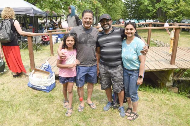 Visitors from Mississauga, Nikita Aaron Savin and Vinaya were all smiles at their first powwow.