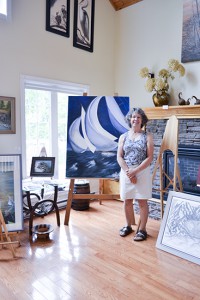 Lorraine Loranger stands next to her large acrylic painting ‘Stormy Seas’ at her home studio, Lorraine’s Art Studio, in Sunsite Estates. Her collection  included multi-media art of birds, wildlife and scenic landscape. 