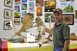 Nick Cywink stands with his acrylic on birch bark pieces at the Wikwemikong Art Gallery.  