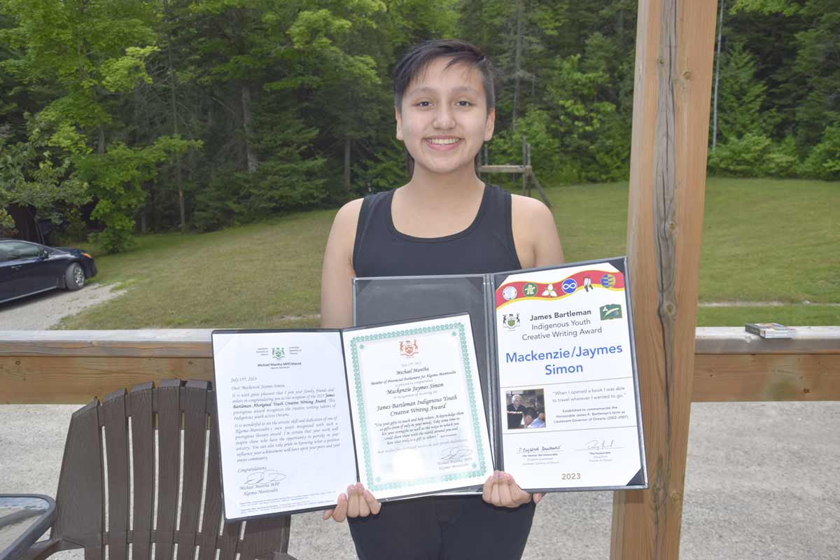 Mackenzie Simon of Sheguiandah First Nation poses with their Bartleman Indigenous Youth Creative Writing Award.