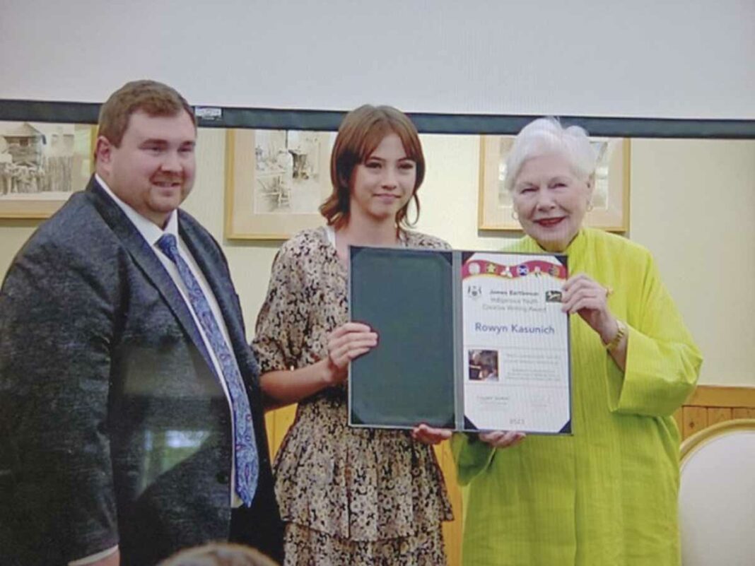 The Honourable Elizabeth Dowdeswell, Lieutenant Governor of Ontario, right, and Michael Ford, minister of Citizenship and Multiculturalism flank Rowyn Kasunich of M’Chigeeng who won a Bartleman Indigenous Youth Creative Writing Award.