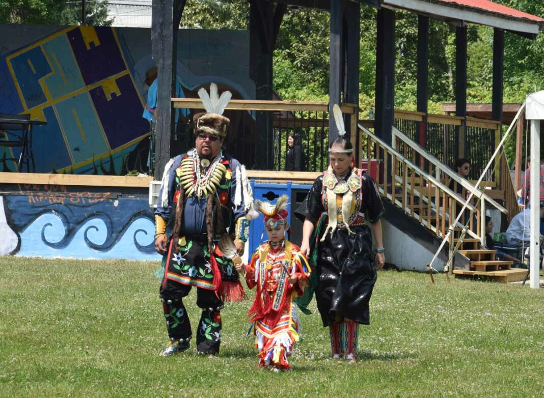 A family in full regalia were enjoying the fine powwow weather at the Buzwah Powwow. photo by Michael Erskine