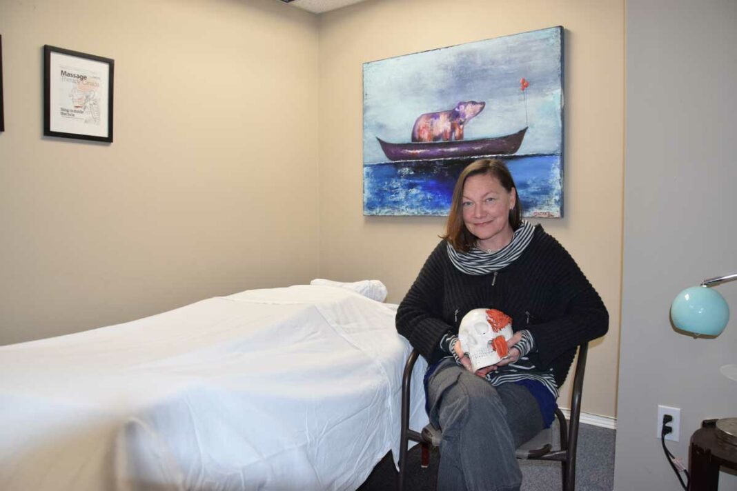 Cheryl Mazak RMT holds one of her favourite props in her new office in Little Current. Ms. Mazak specializes in treatment plans for auto accident victims and throat and speech issues that can be treated with massage therapy. photo by Michael Erskine