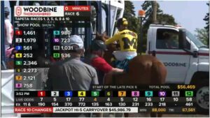 Clive’s jockey gets him into position in the chute at Woodbine in his maiden race. Notice the jockey’s special Manitoulin-themed jersey.