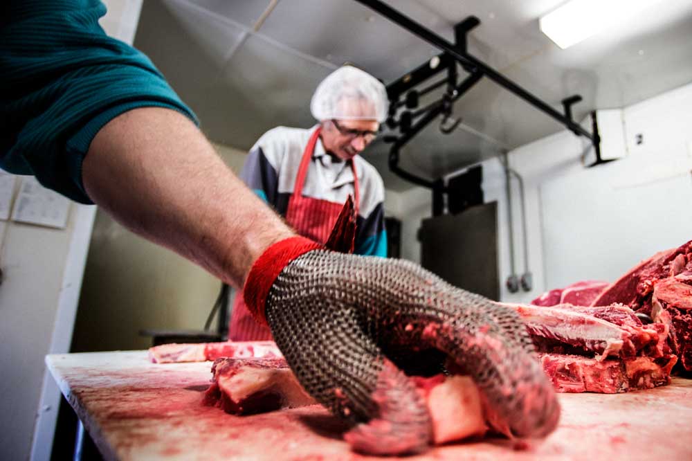 Max Burt and Lee Hayden hard at work in the butcher shop.