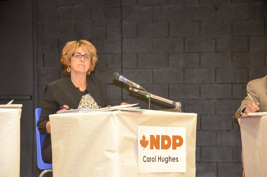 Carol Hughes, NDP MP incumbent, takes in a question from the floor.