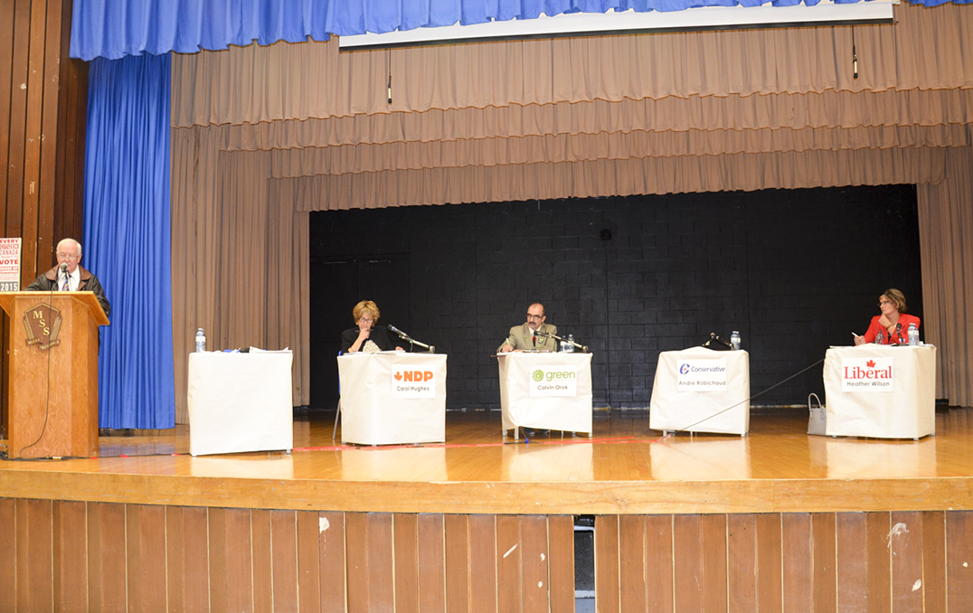 From left, Jim VanCamp, moderator, Carol Hughes, NDP MP incumbent, Cal Orok, Green Party candidate, an empty chair for André Robichaud, Conservative candidate, and Heather Wilson, Liberal candidate at The Expositor’s All-Manitoulin Candidates’ Night. photo by Michael Erskine 