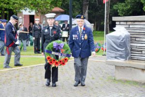 Royal Canadian Legion member Linda Bowerman is escorted to the wreath laying ceremony by a member of the Manitoulin Sea Cadet Corps as she lays a wreath for her Branch 177 Little Current.