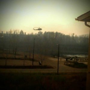 A water bomber helicopter drops down to scoop up water, providing an entertaining diversion from the Hiller’s balcony until the full gravity and threat of the situation became clear.