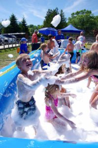 Kids dive into a pool of bubbles during the kids ‘foam party’ hosted by ‘It’s Not a  Party Without Us.’