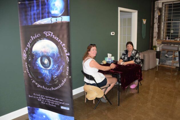 Psychic Chantele, left, prepares to give a reading to a client.