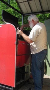 Wayne Tuffin serves up a delicious sausage from his 19 square foot (cooking  capacity) smoker.