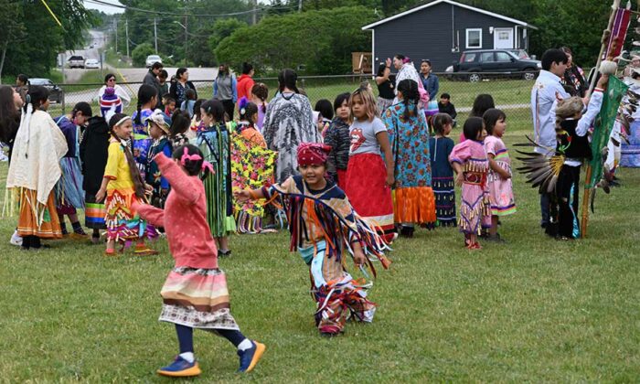 Excited young dancers enjoy the outdoor event during the Wiikwemkoong Junior School Powwow. photos by Dwayne Animikwan