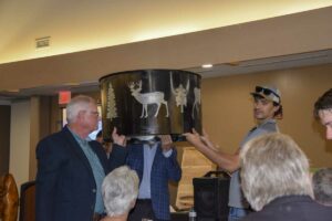 A fire pit goes up for live auction. photo by Michael Erskine