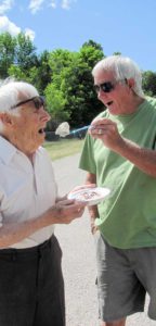 Mayor Aus Hunt enjoys an ice cream sundae fed to him by Mike Farquhar. 