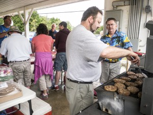 Manning the barbecue grill in the pavilion for the ravenous lunchtime crowd are Wes Newburn (front) and Al Tessie.