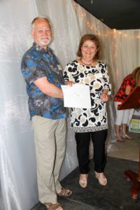 La Cloche Art Show Committee Chair Carmela Ciccarelli presents Best of Show winner David Read with his certificate for his piece ‘Flowing Rocks.’