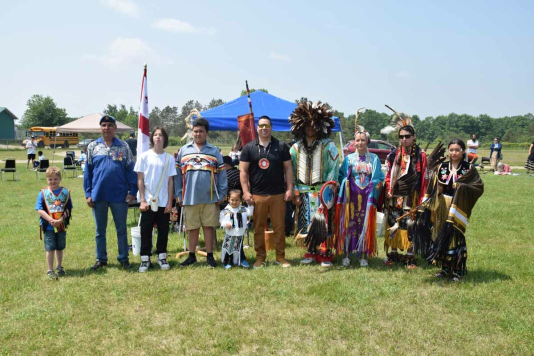 The head grand entry crew gather for a photograph after the entry was complete at Lakeview School. photo by Michael Erskine