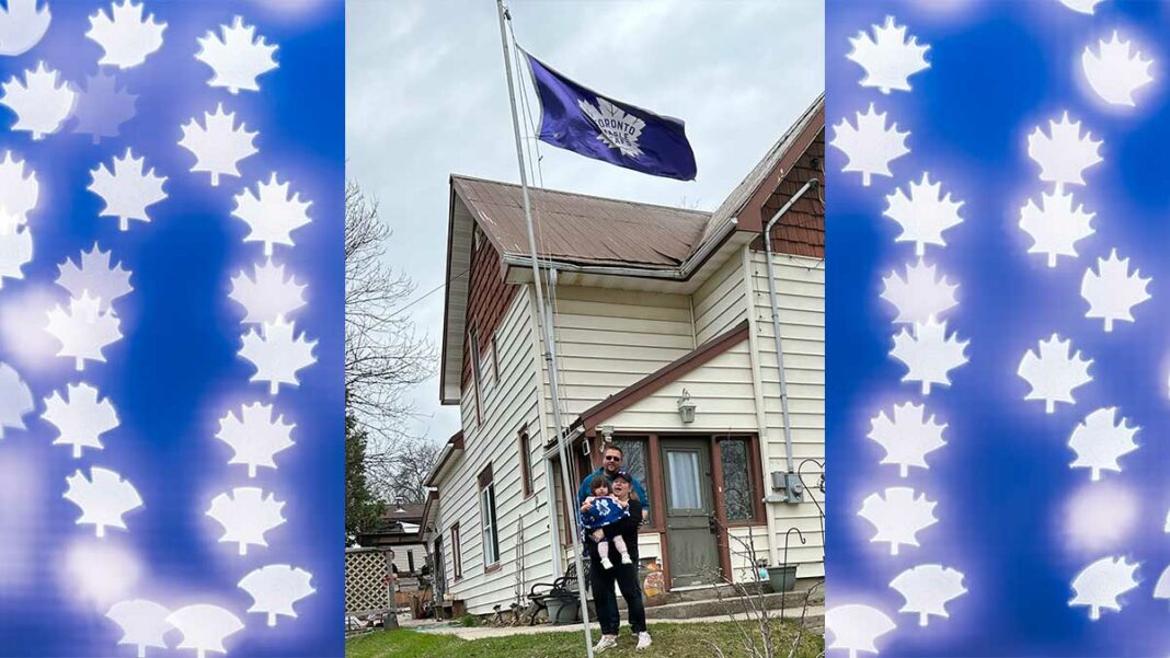 FINALLY!—Kevin and Mel Aelick and granddaughter Juniper pose happily under the Toronto Maple Leafs hockey team flag that flies hopefully in front of their Robinson Street home in Little Current, year-‘round. The moment was last Sunday morning, following the Leafs overtime victory in the quarter-finals against the powerhouse Tampa Bay Lightening the night before, the team’s first post-season series win in 19 years. Little Juniper is wrapped, of course, in a Maple Leafs-themed blanket! The Leafs will face the Florida Panthers in the next round while the Aelicks’ flag will remain proudly flying.