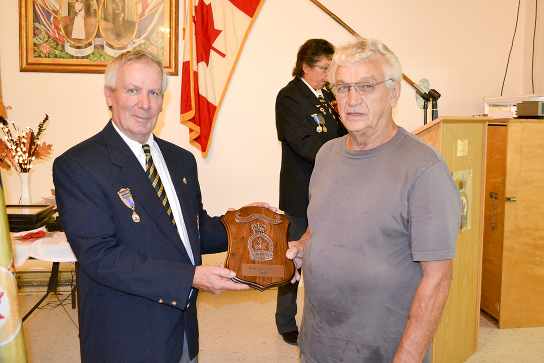 Comrade Tom Stephens presents Ron Bowerman, right, with the Legionnaire of the Year Award for his many volunteer efforts with the branch.