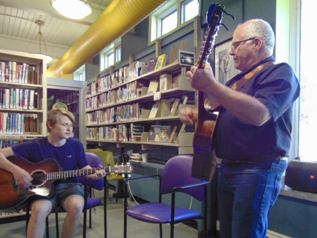 Cole Hughson and George Williamson performing at the NEMI Public Library open mic event. photo by Margery Frisch.