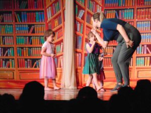 Candice Irwin, right, and some of the youngest members of the ensemble have crept into the closed library, intent on causing mischief. photo by Margery Frisch.