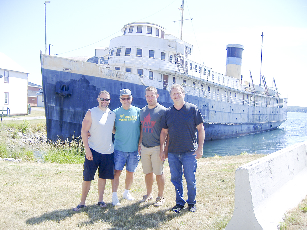 Members of the Mielke family pay a nostalgic visit to the Norisle, docked in Manitowaning. They took this ferry to the Island until it was replaced in 1974 by the Chi-Cheemaun. Second from left is Chuck Mielke with son Jeffrey, left, nephew Matt and oldest son Chuck jr.