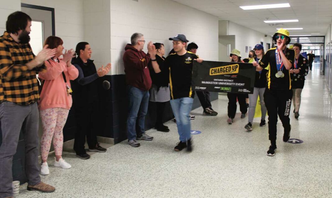 All charged up! Manitoulin Secondary School Manitoulin Metal Robotics 6865 team members, led by left in photo Patrick McCann and Ben Willis took part in the hallway victory run last Wednesday morning at the school. The celebration was in recognition of the team having won the Robotics World Championship FIRST Robotics Impact Finalist Award, and the provincial championships. School teachers and fellow students clapped, cheered and high-fived members of the team as they made their victory lap around the school.