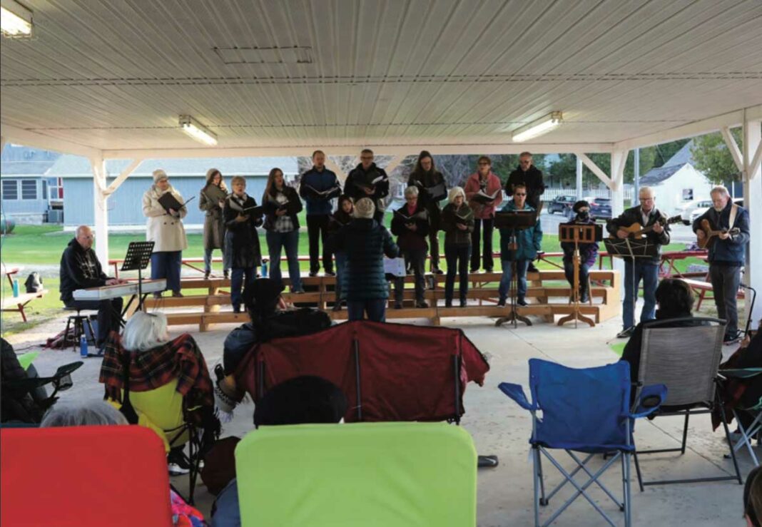 The Manitoulin Community Choir took full advantage of the warming spring weather to hold an outdoor concert that presented each song with power and energy. photo by Maggie Leclair