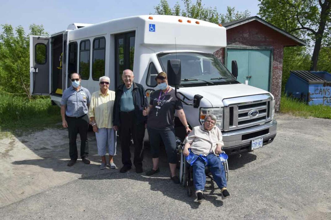 Manor administrator Don Cook, left, is joined by residents Jean Pearson, Bill Trainor, activities coordinator Julie Omnet and resident Marie Cranston beside the Manor’s new shuttle bus. The new-to-the-Manor vehicle formerly served as the Angel Bus out of Gore Bay. photo by Michael Erskine.