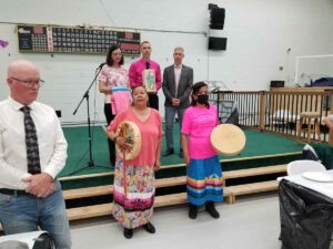 Mary Buie’s children Jennifer, Robert and Neil bore her ashes into the celebration of life held at the M’Chigeeng Community Centre accompanied by an honour song. Ms.Buie worked at the M’Chigeeng Health Centre following her retirement as a midwife and nurse. photo by Michael Erskine