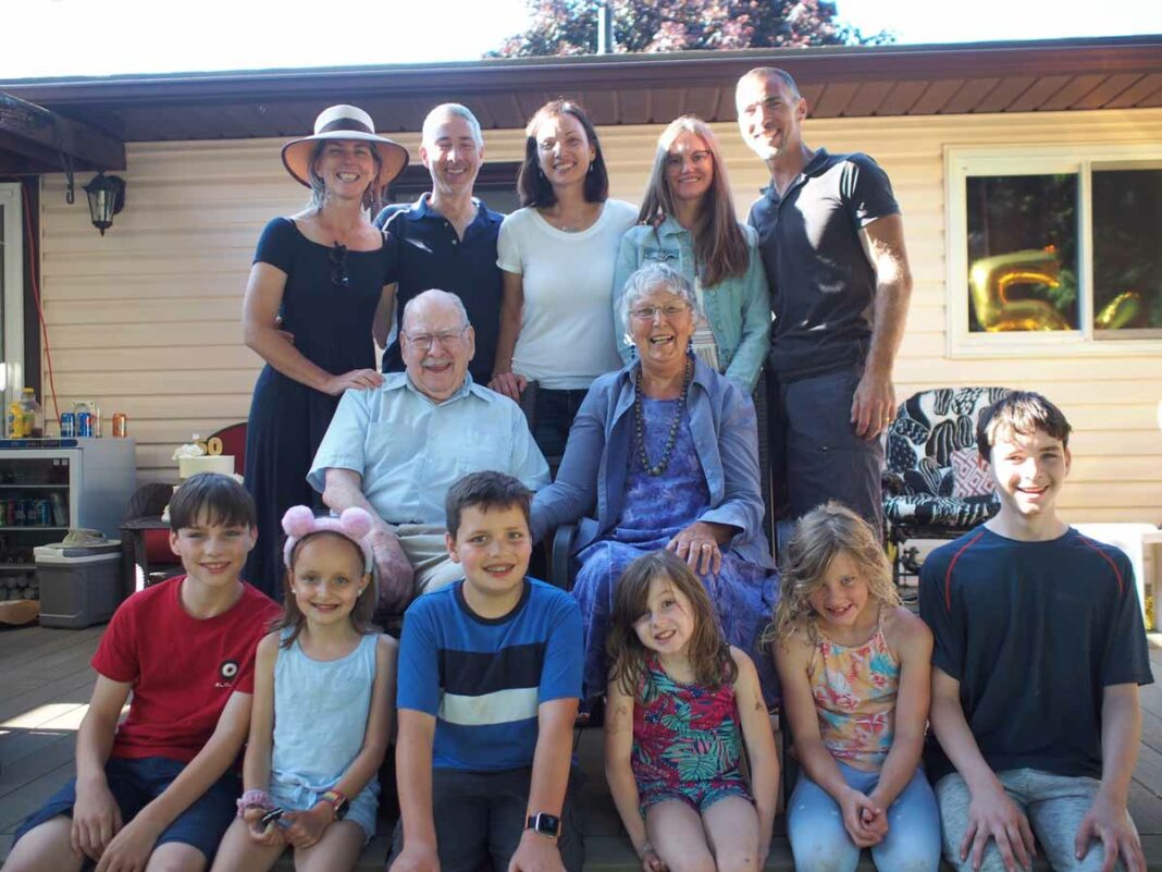 The late Mary Buie and her husband John (who predeceased her less than three months before), centre, are flanked by their children and their spouses (above), and gandchildren (below).