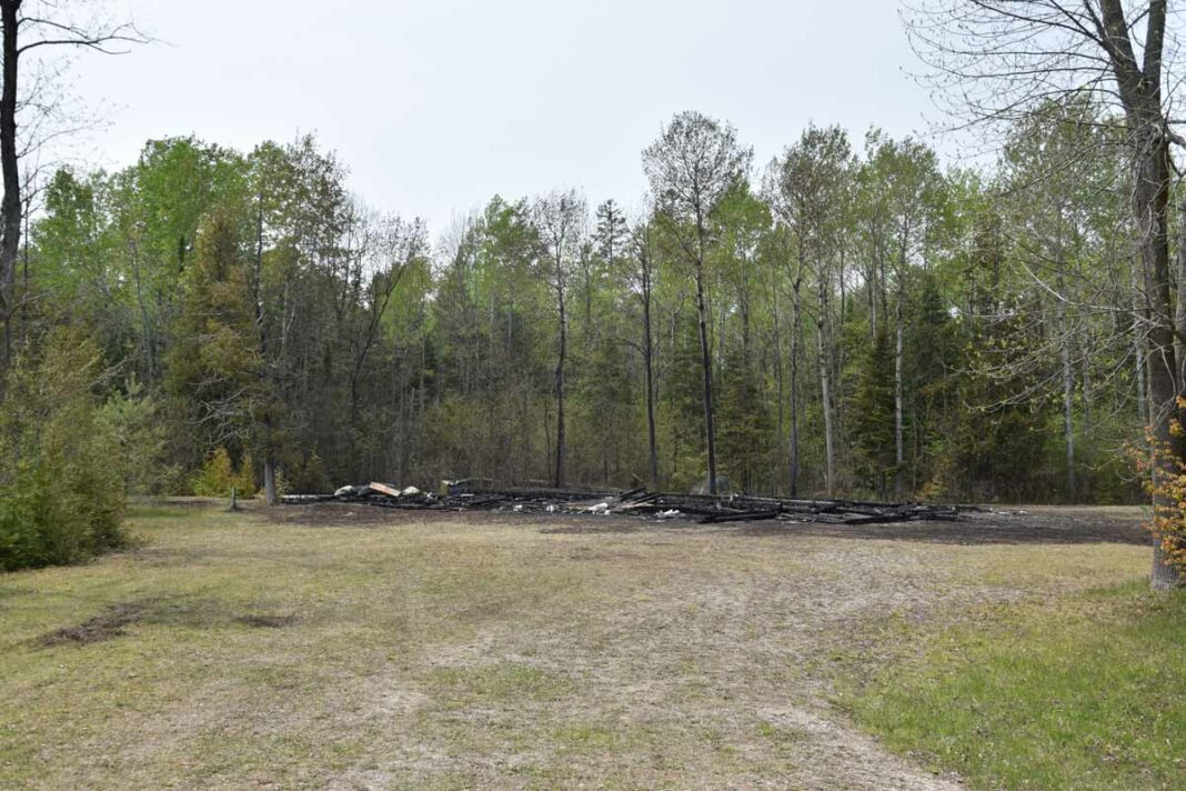 A vacant building, that was once hoped to be an abattoir, on the M’Chigeeng First Nation was razed in a recent fire. All that remained was a smouldering pile of ash. Police are treating it as suspected arson. photo by Michael Erskine.