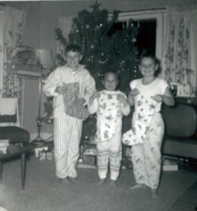 Bill, Mary Lou and Jim Mac check their Christmas stockings.