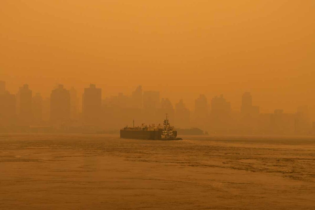 An apocalyptic view of the Manhattan skyline from the East River due to smoke from Canadian wildfires last week. Shutterstock