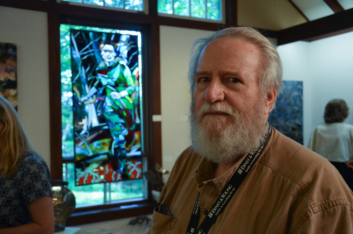 Hayden Butler places numerous images with  symbolic meanings in his stained glass creations such as this Nordic inspired image of spring emerging from the forest entitled ‘Approaching Spring.’