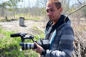 Videographer Matthew Manitowabi creates a  documentary recording of the permaculture design course events.