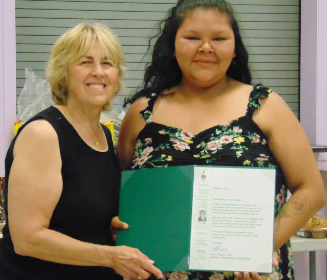 Algoma-Manitoulin-Kapuskasing Carol Hughes, left, presents Monica Shawanda with a commendation for her lifesaving efforts last year. Monica’s brother, Nathan, was also commended for his good deeds.