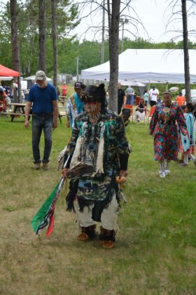 A men’s traditional dancer takes part in an intertribal dance to kickstart the powwow.