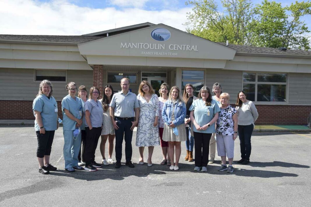 Members of the Manitoulin Family Health Team gather in front of the office for a group photo with Smith Family Foundation representative Jeff Smith. From left are Lori Oswald, Dr. Maurianne Reade, Julia Sheppard, Amy Wheale, Thao Dao, Jeff Smith, Dr. Maryna Harelnikava, Lianne Charette, Waunita Hopkin, Collin Corbiere, Heather McGauley, Meggin Morgan, Lenora Tann and Rosalind Seabrook. photo by Michael Erskine