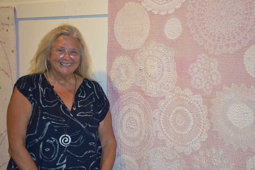 Time features prominently throughout the exhibit. These doilies are an example having been donated to the artist throught the years. photo by Michael Erskine