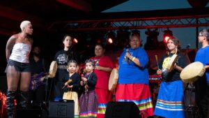 Musician Jully Black watches on as the Wiiikwemkoong hand drummers perform. photo by Ashely Manitowabi